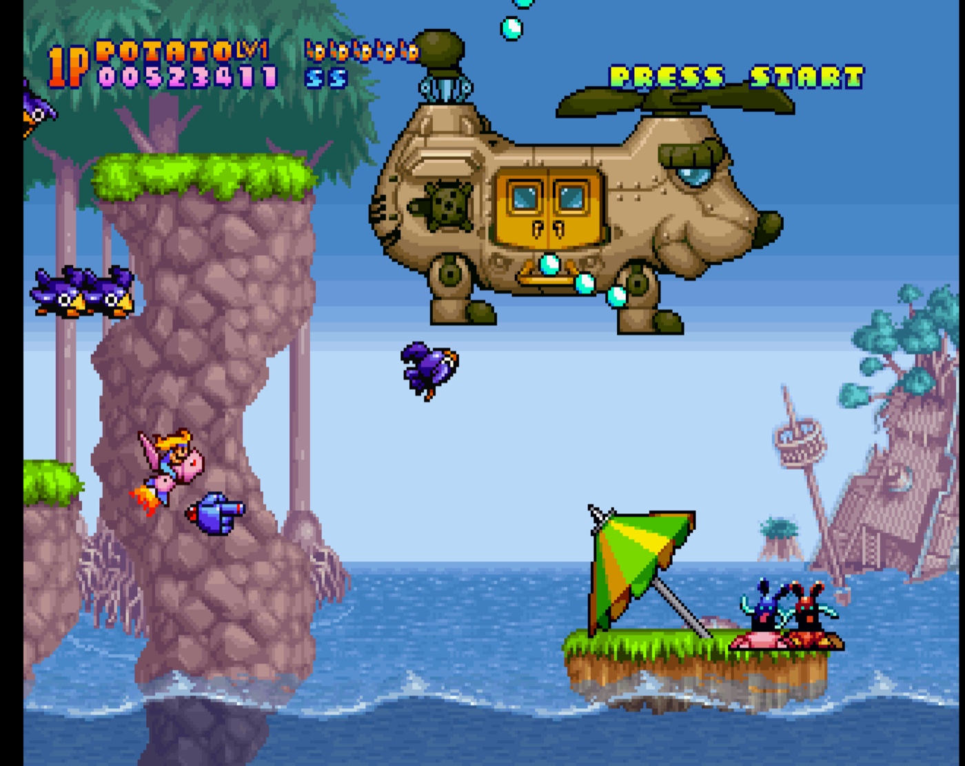 A patchwork helicopter boss over the sea with a raft of onlookers below.